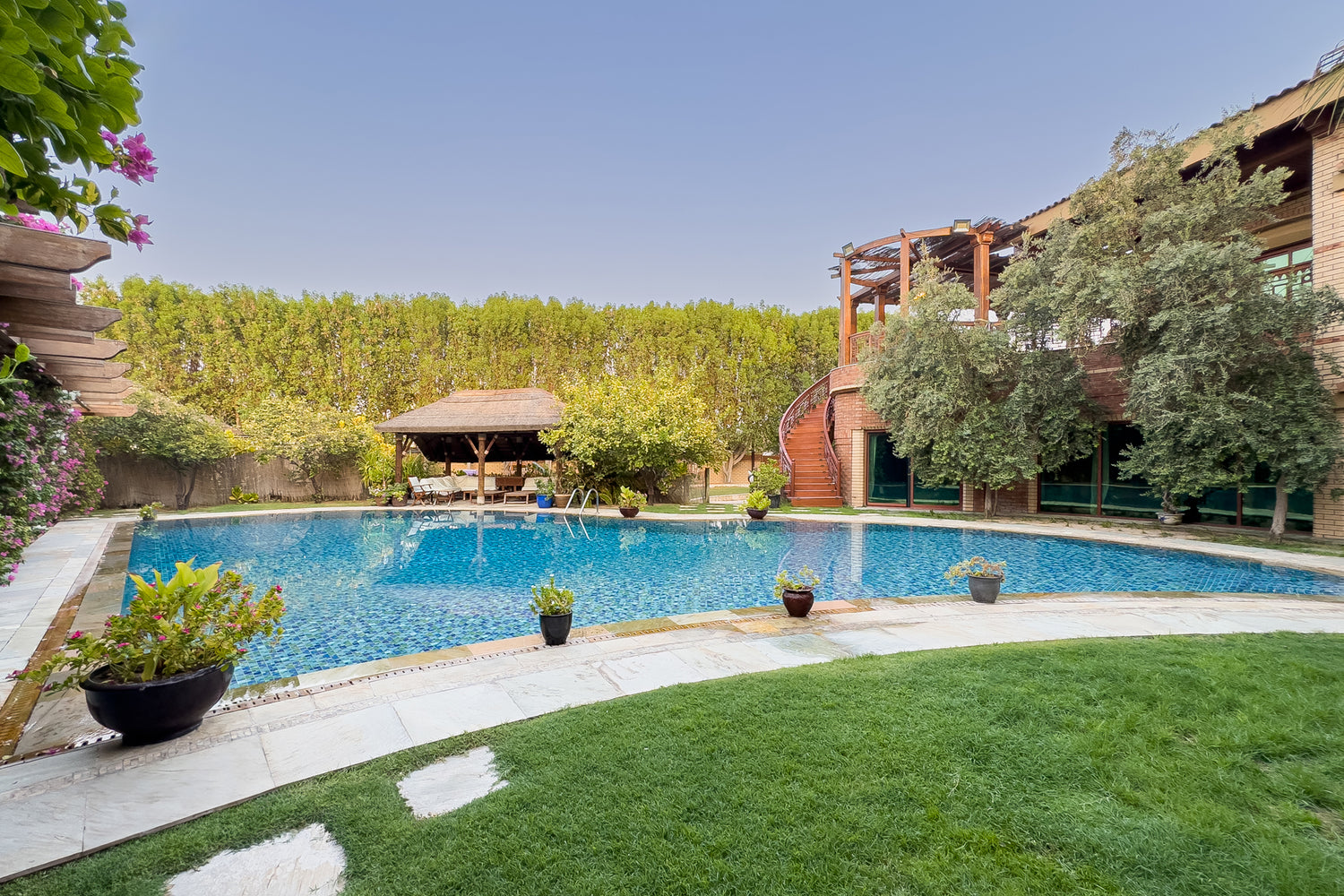 Swimming pool in a villa garden surrounded by trees