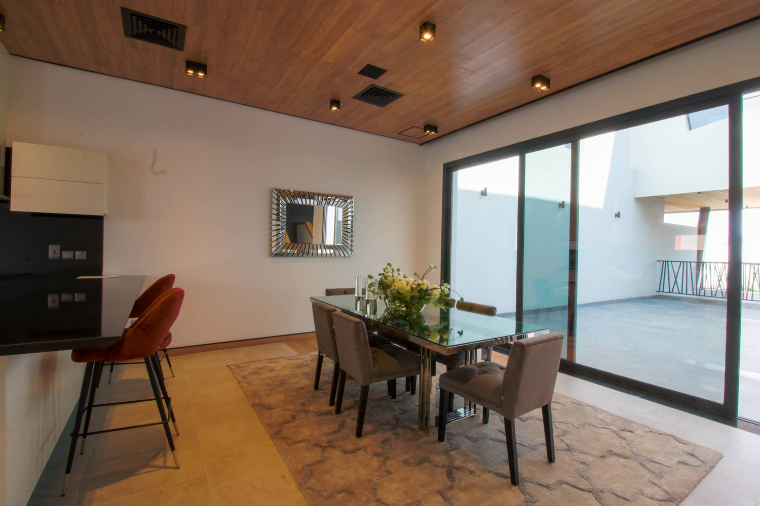 Dining table next to a large window and balcony